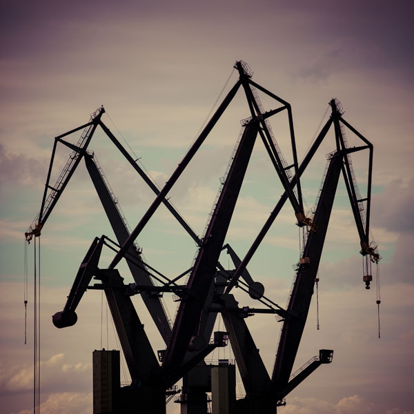 3 tower cranes operating in a construction site