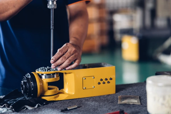 A mechanic working on crane parts