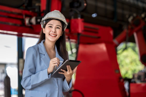 A maintenance manager reviewing a crane lubrication schedule