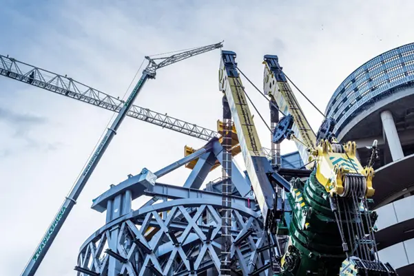 Several large industrial cranes in use during the redevelopment of a major building
