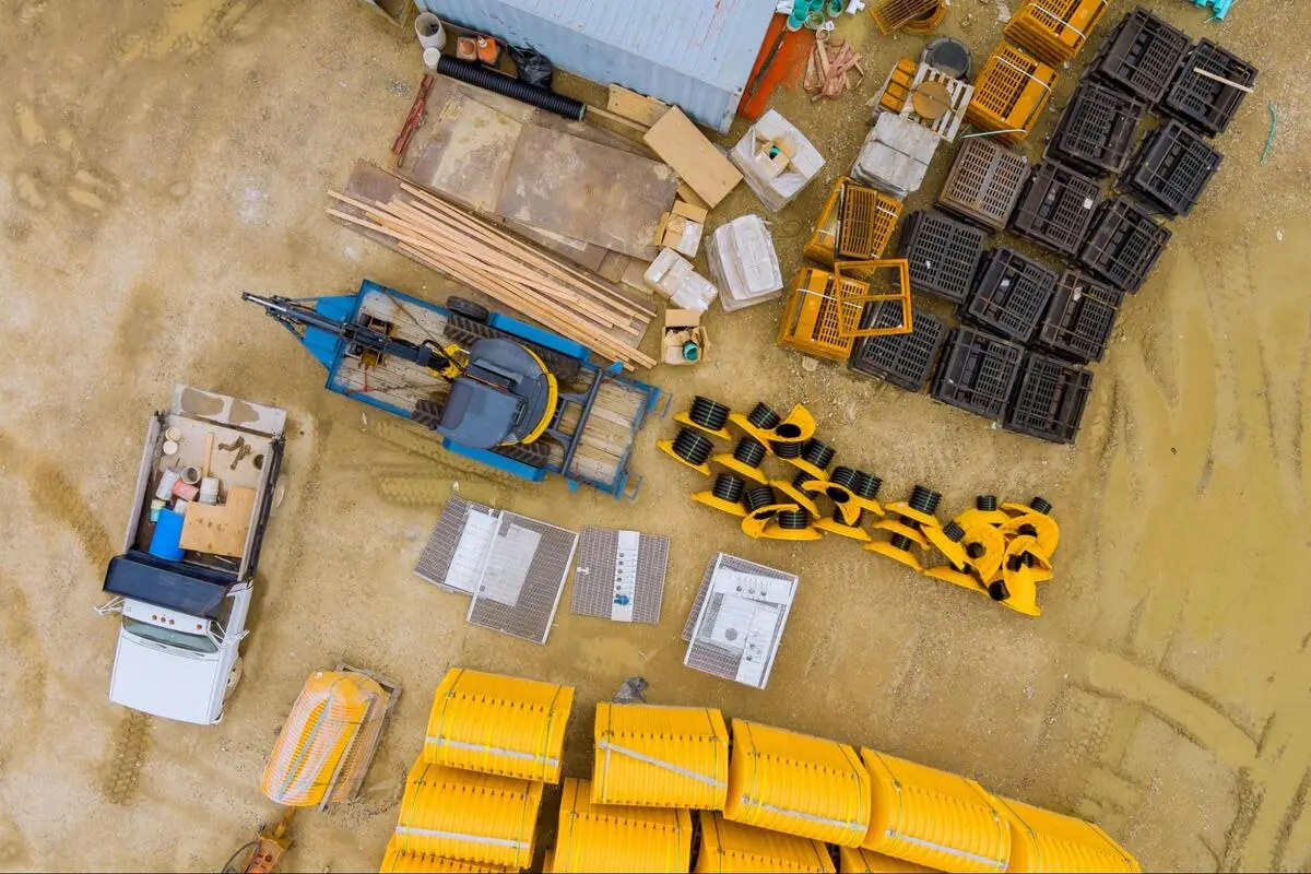 Aerial View of Construction Site with Terex Parts and Equipment Aerial view of a construction site with Terex parts, machinery components, pallets, and equipment arranged on dirt ground