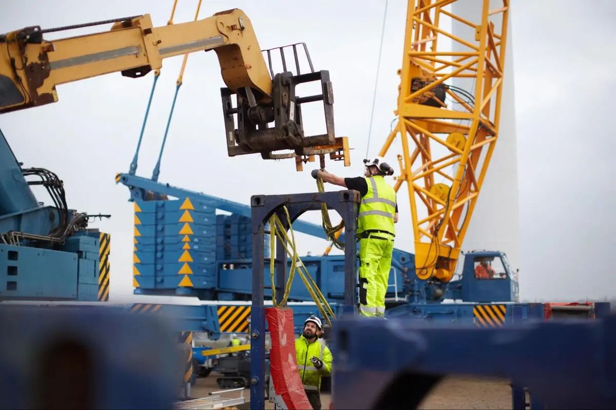 Crane Safety Inspection; OEM Part Replacement Documentation Crane maintenance technicians conducting a safety inspection at an active construction site